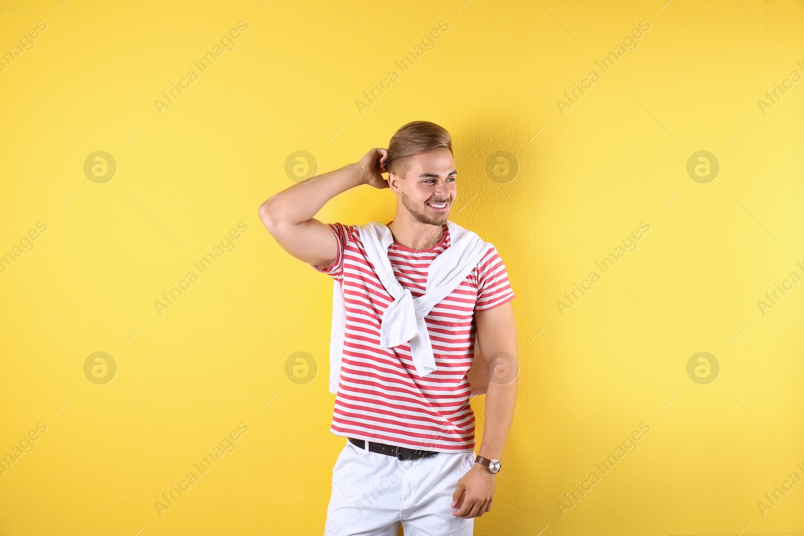 Photo of Young man with trendy hairstyle on color background