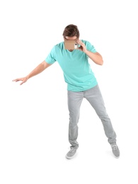 Young man using cardboard virtual reality headset, isolated on white