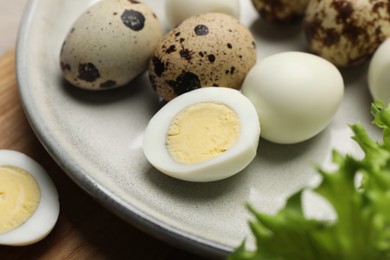 Photo of Unpeeled and peeled hard boiled quail eggs on plate, closeup