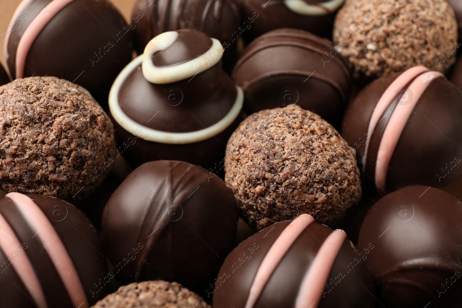 Photo of Many different delicious chocolate truffles, closeup view