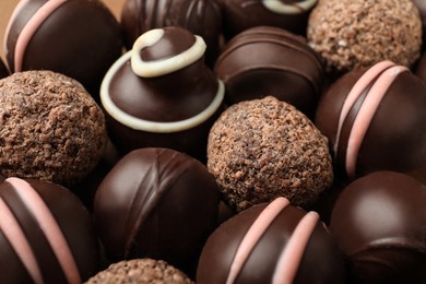 Photo of Many different delicious chocolate truffles, closeup view