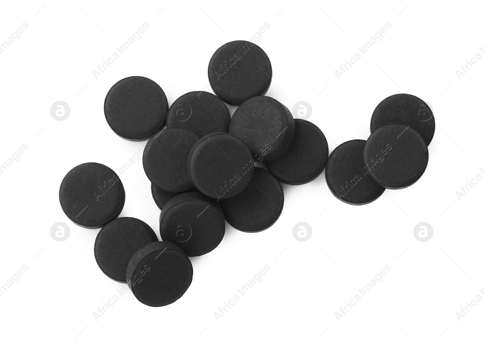 Photo of Activated charcoal pills on white background, top view. Potent sorbent