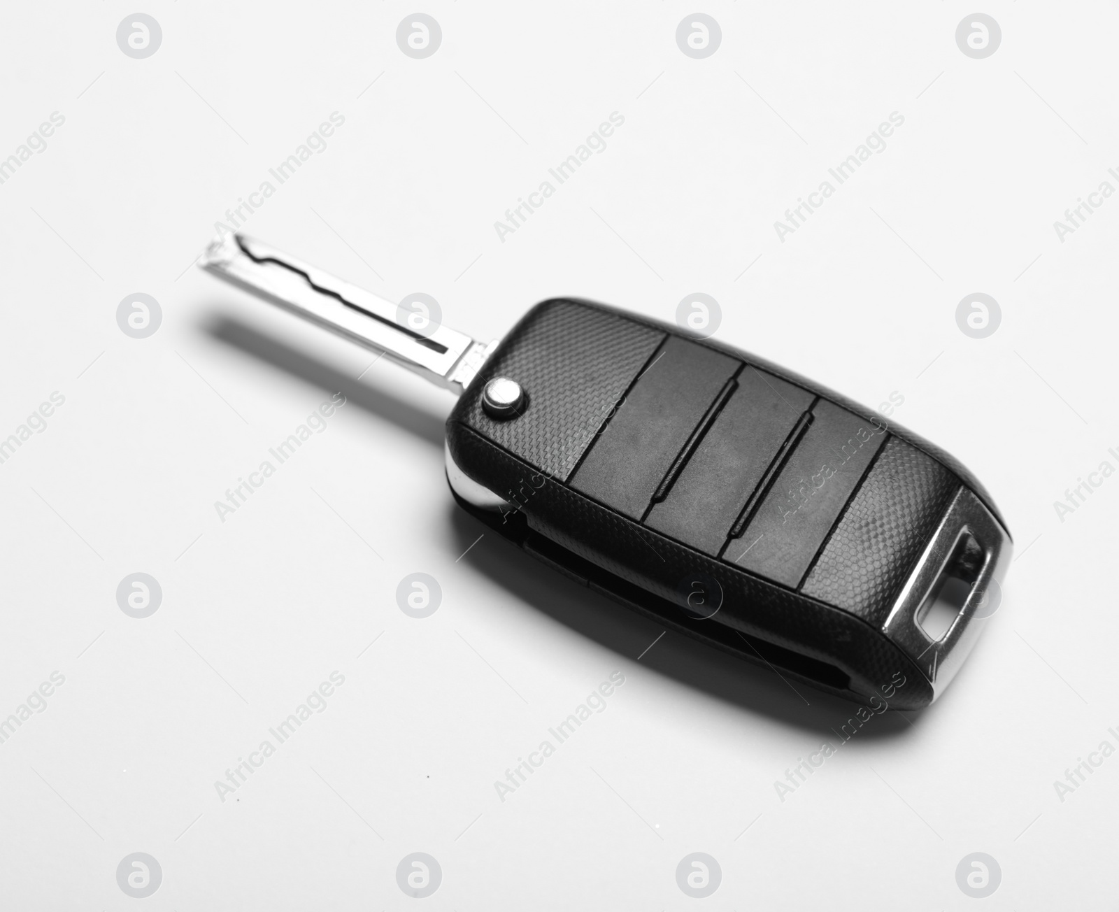 Photo of New modern car key on white background