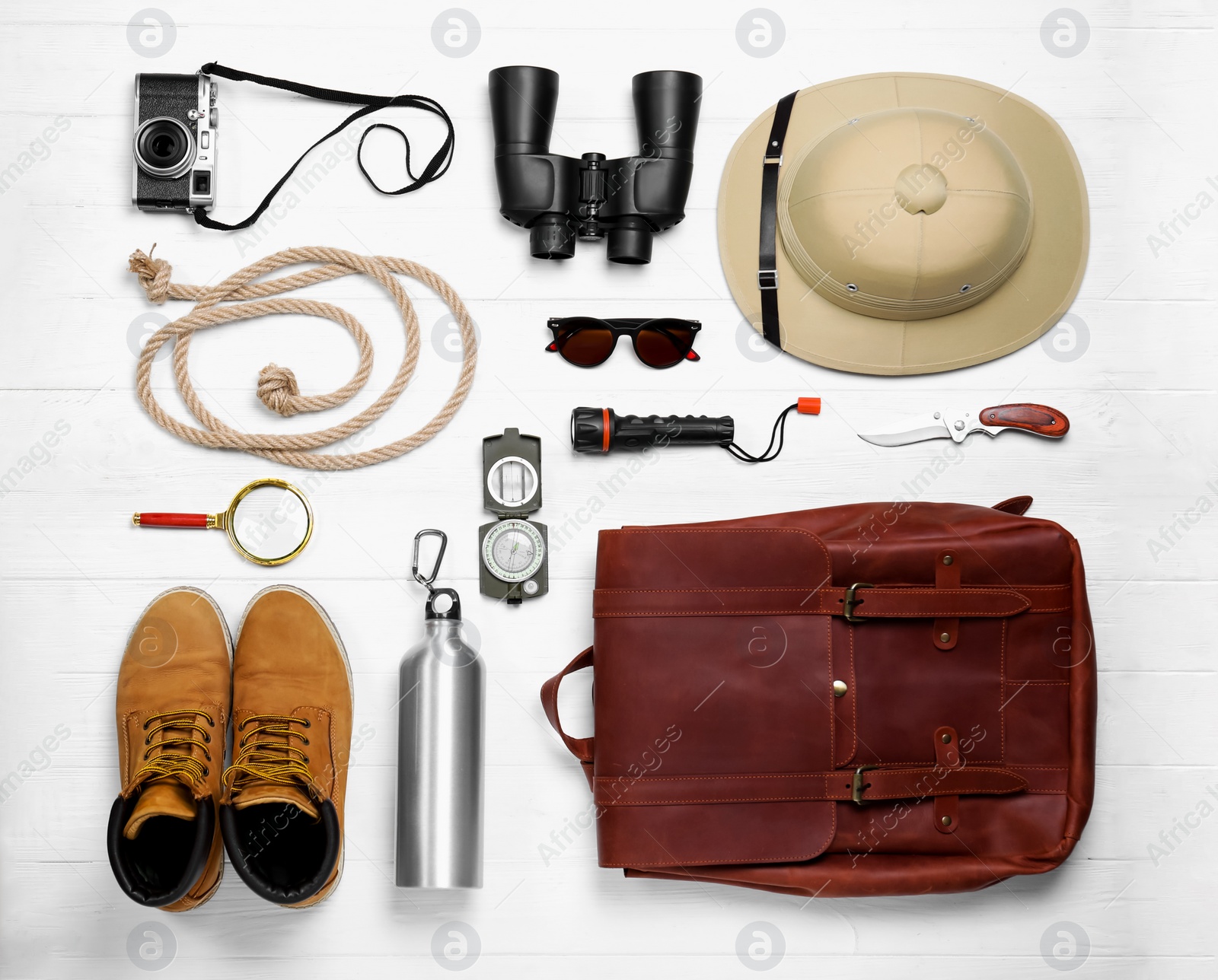 Photo of Flat lay composition with different safari accessories on white wooden background