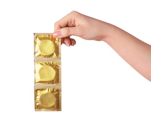 Woman holding condoms on white background, closeup