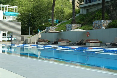 Photo of Outdoor swimming pool and sunbeds at resort on sunny day