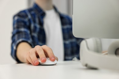 Photo of Teenage boy using computer indoors, closeup. Internet addiction
