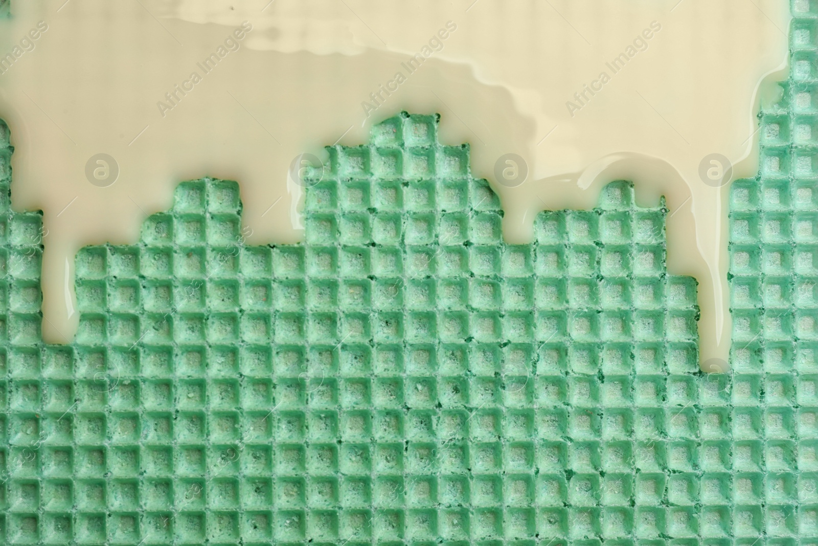 Photo of Hot white chocolate on wafer, closeup. Crispy food