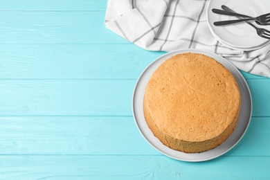 Photo of Delicious fresh homemade cake on light blue wooden table, top view. Space for text