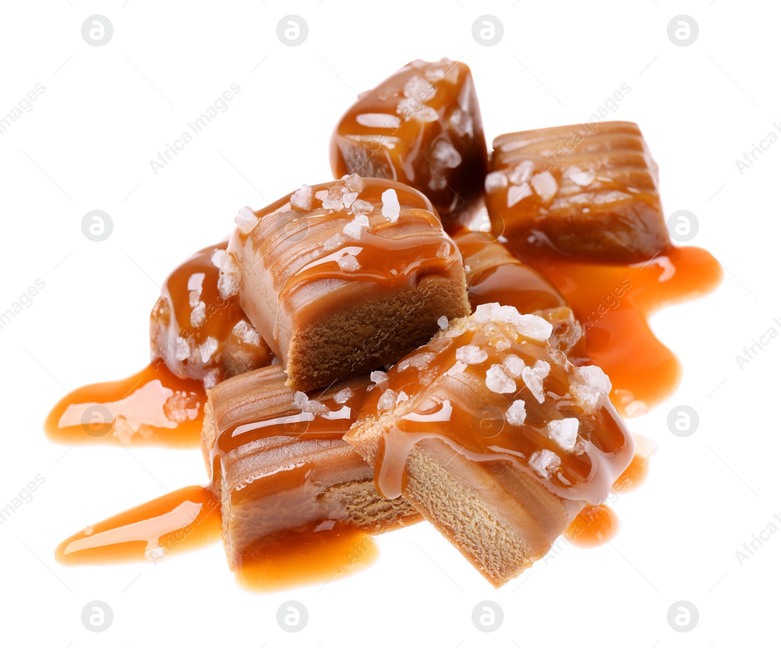 Photo of Delicious salted caramel with sauce on white background