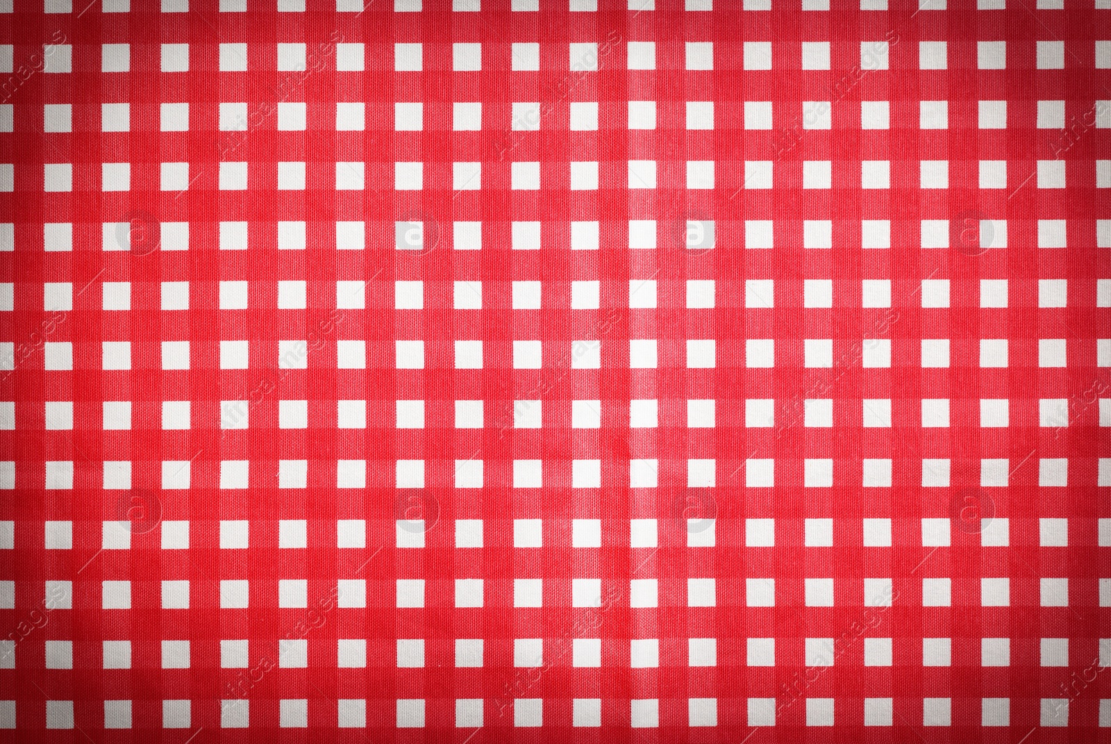 Image of Red and white tablecloth as background, vignette effect