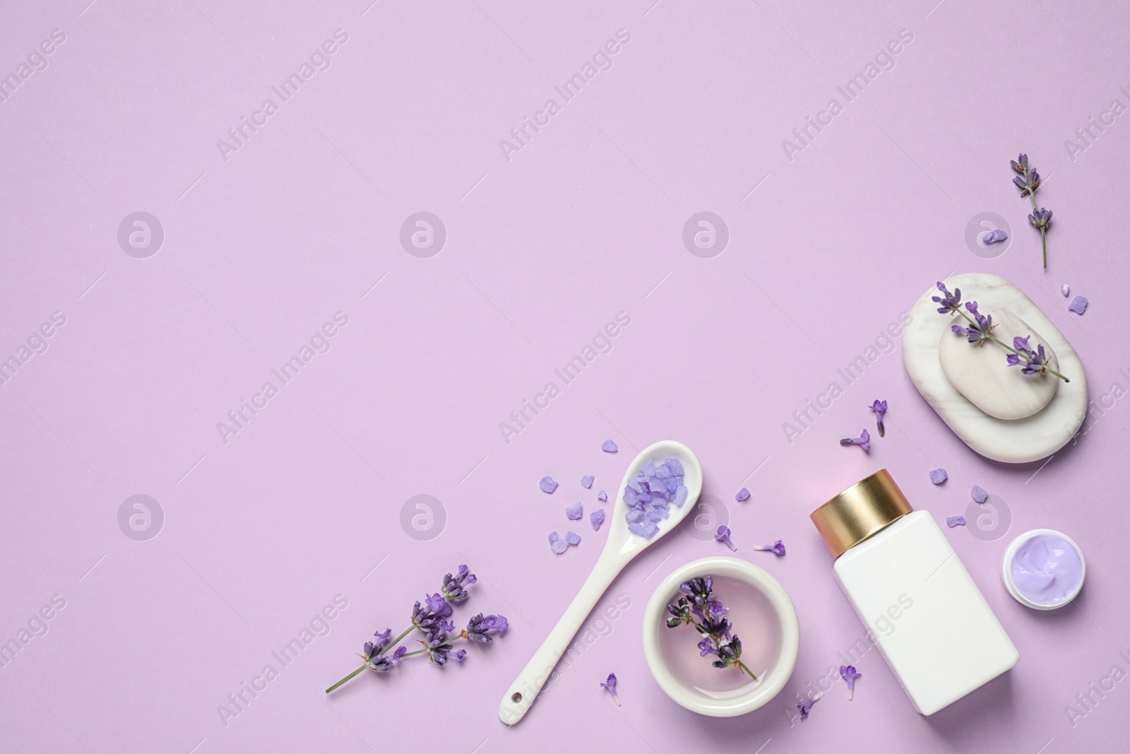 Photo of Cosmetic products and lavender flowers on lilac background, flat lay. Space for text