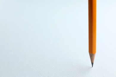 Photo of One sharp graphite pencil on white background, closeup. Space for text