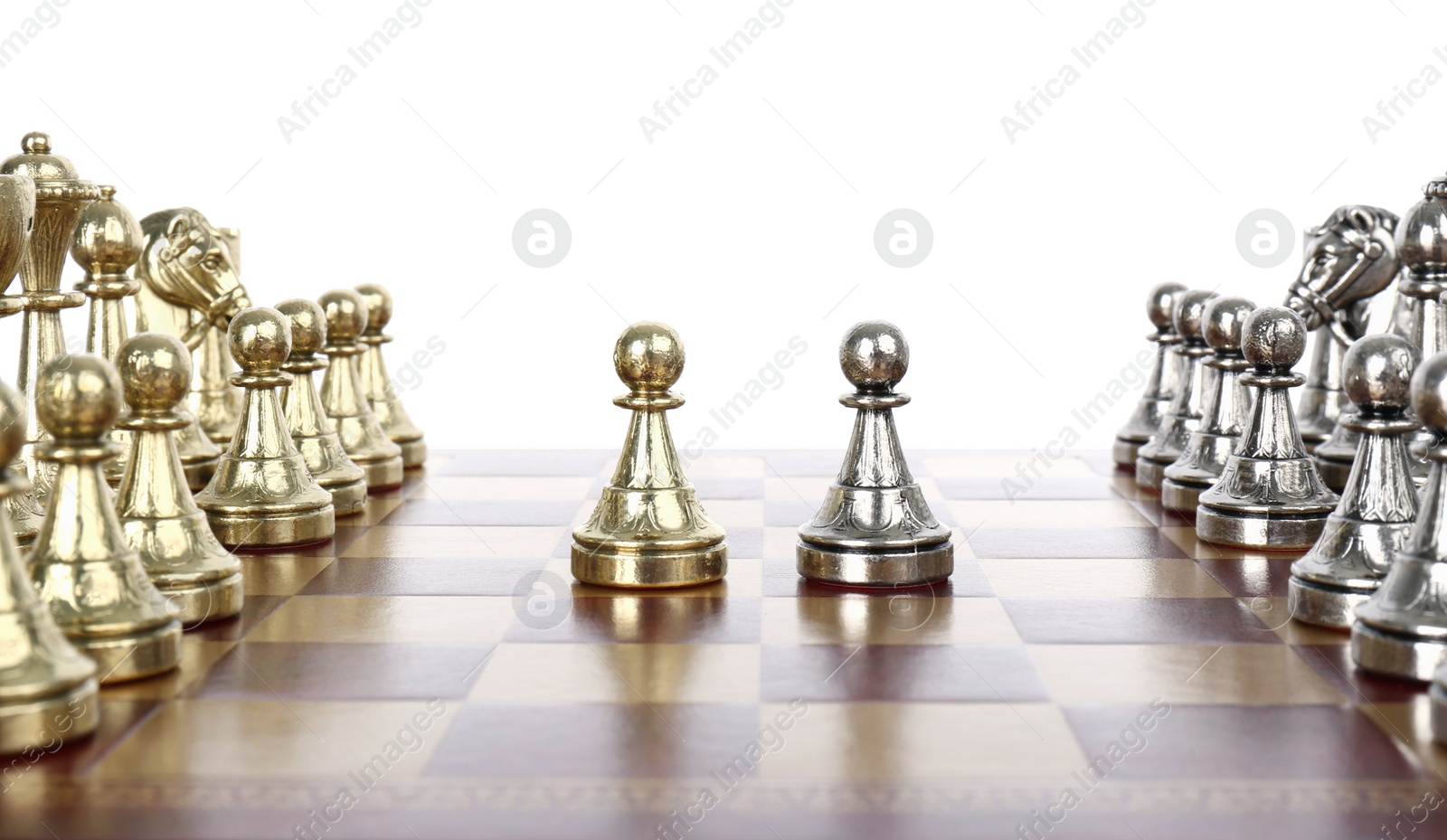 Photo of Chess pieces on wooden board against white background