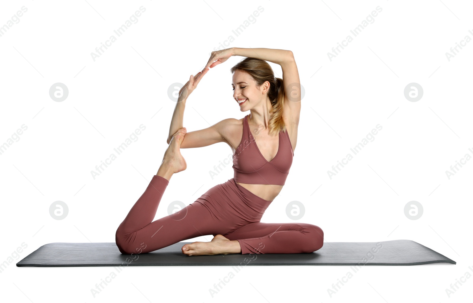 Photo of Young woman in sportswear practicing yoga on white background