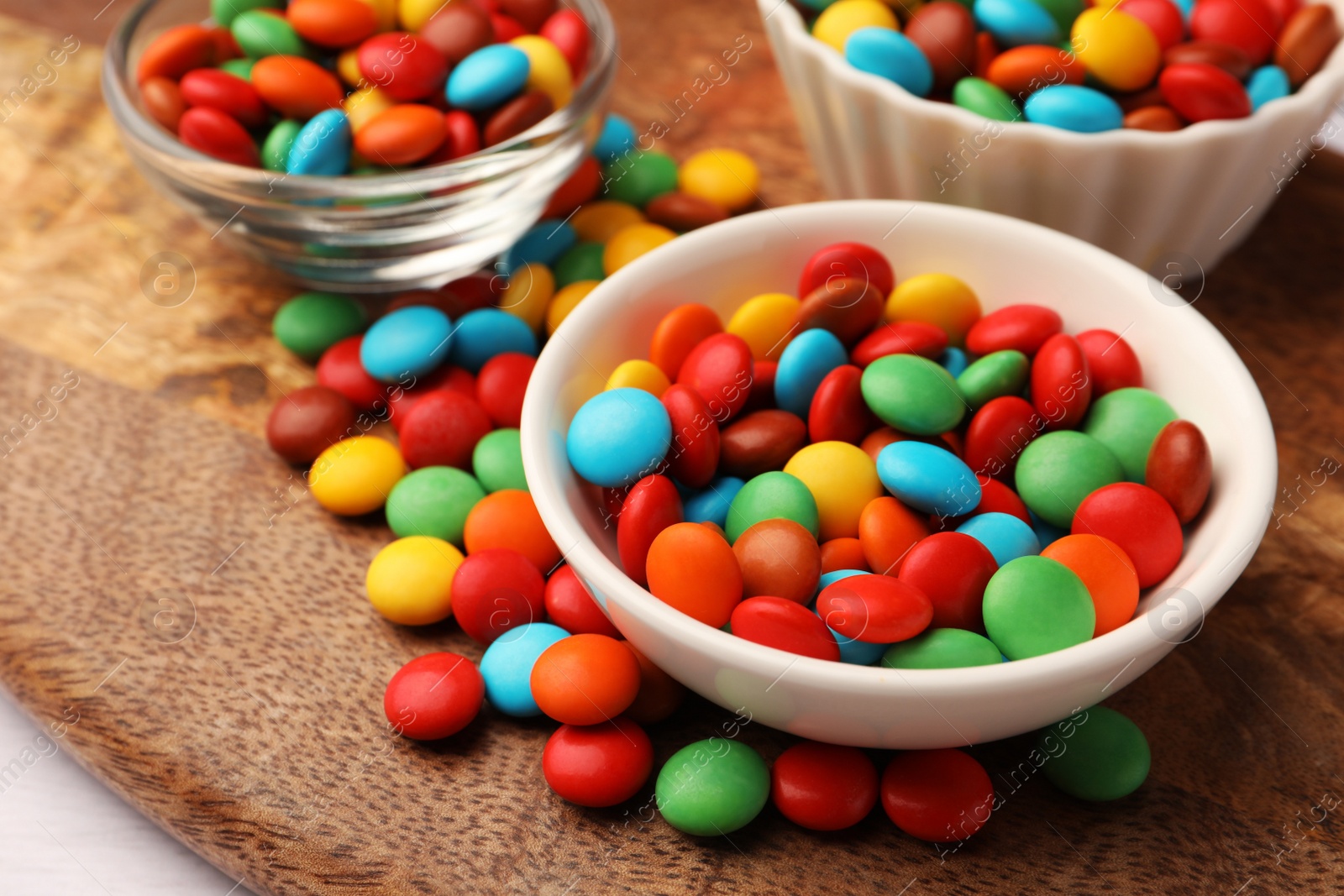 Photo of Tasty colorful candies on wooden table, closeup