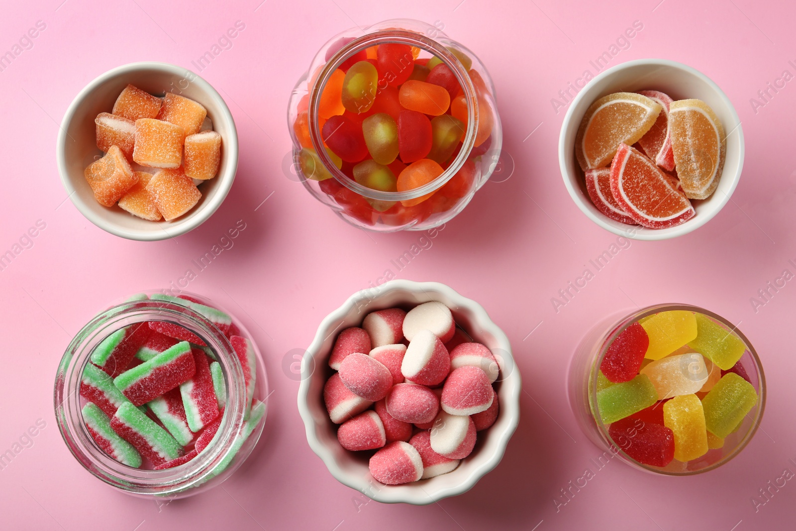 Photo of Flat lay composition with different jelly candies on pink background