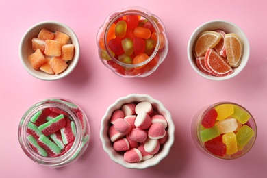 Photo of Flat lay composition with different jelly candies on pink background
