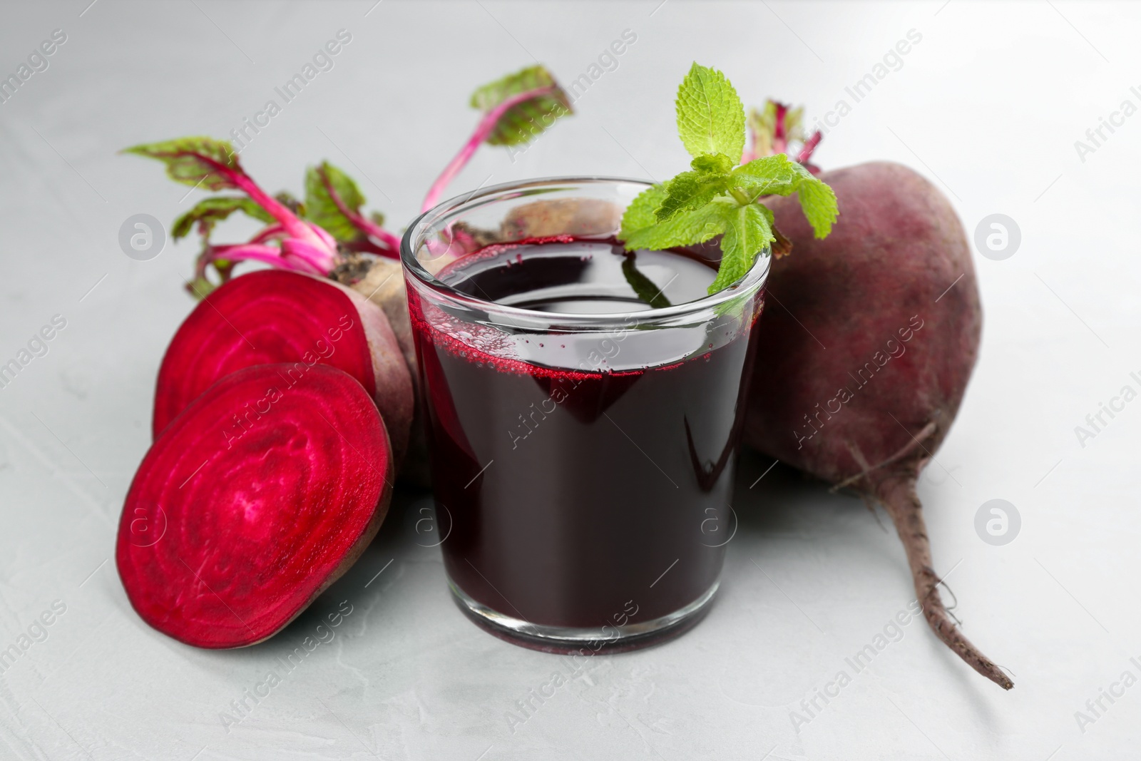 Photo of Freshly made beet juice on grey table