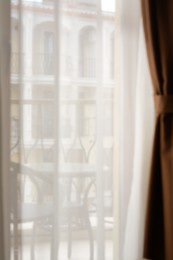 Photo of Window behind white curtain indoors in morning