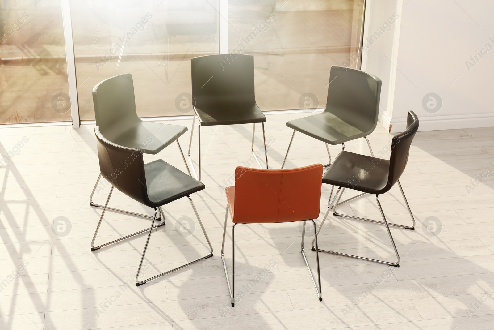 Photo of Chairs prepared for group therapy session in office. Meeting room interior