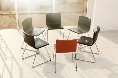 Photo of Chairs prepared for group therapy session in office. Meeting room interior