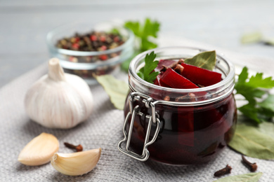 Delicious pickled beets and spices on table