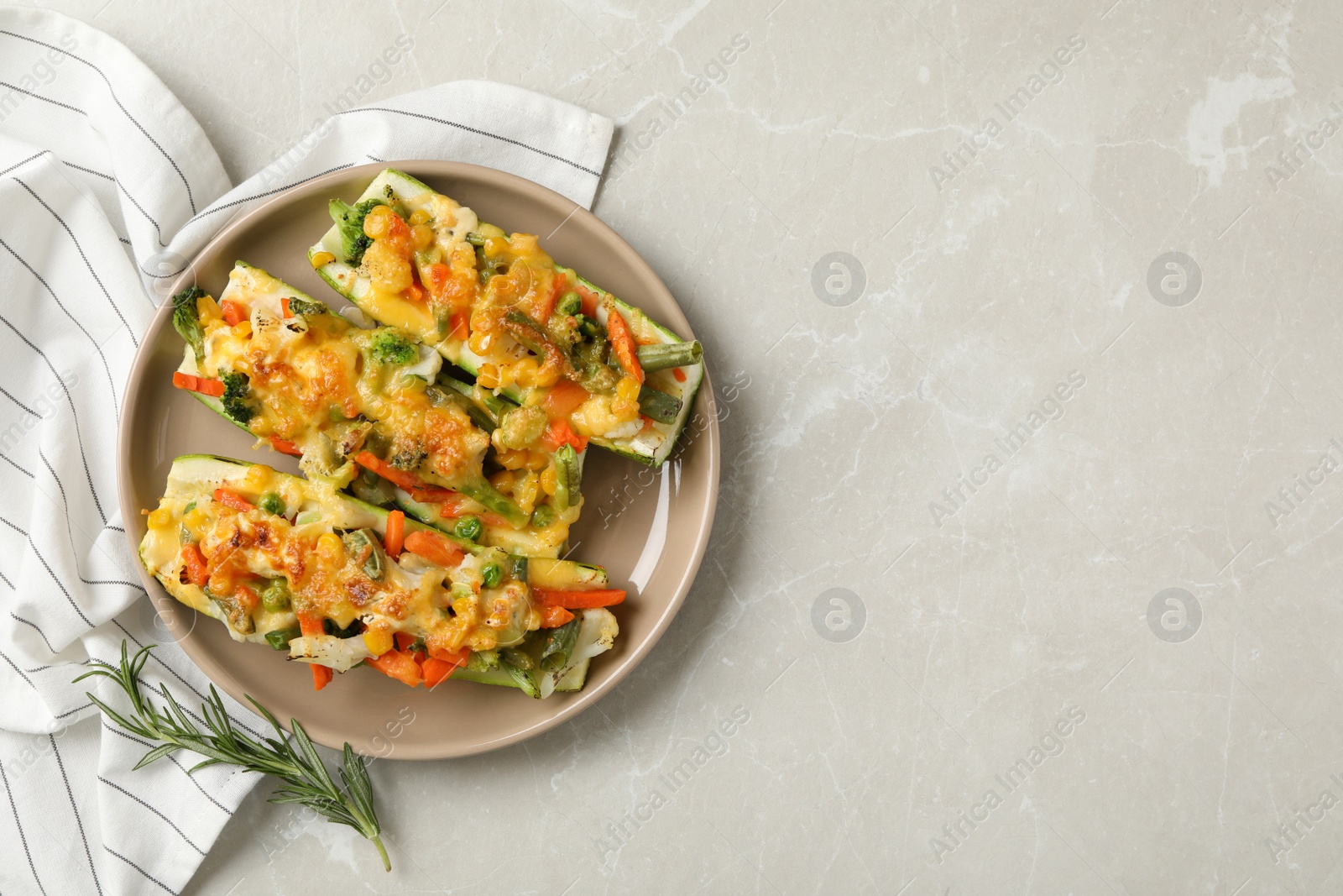 Photo of Baked stuffed zucchinis served on light grey table, flat lay. Space for text