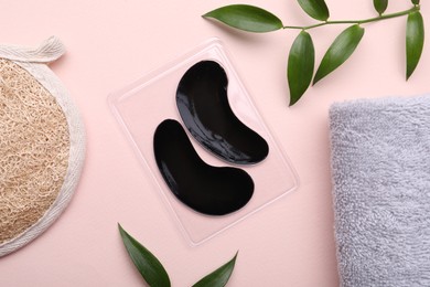 Photo of Flat lay composition with under eye patches on light pink background. Cosmetic product