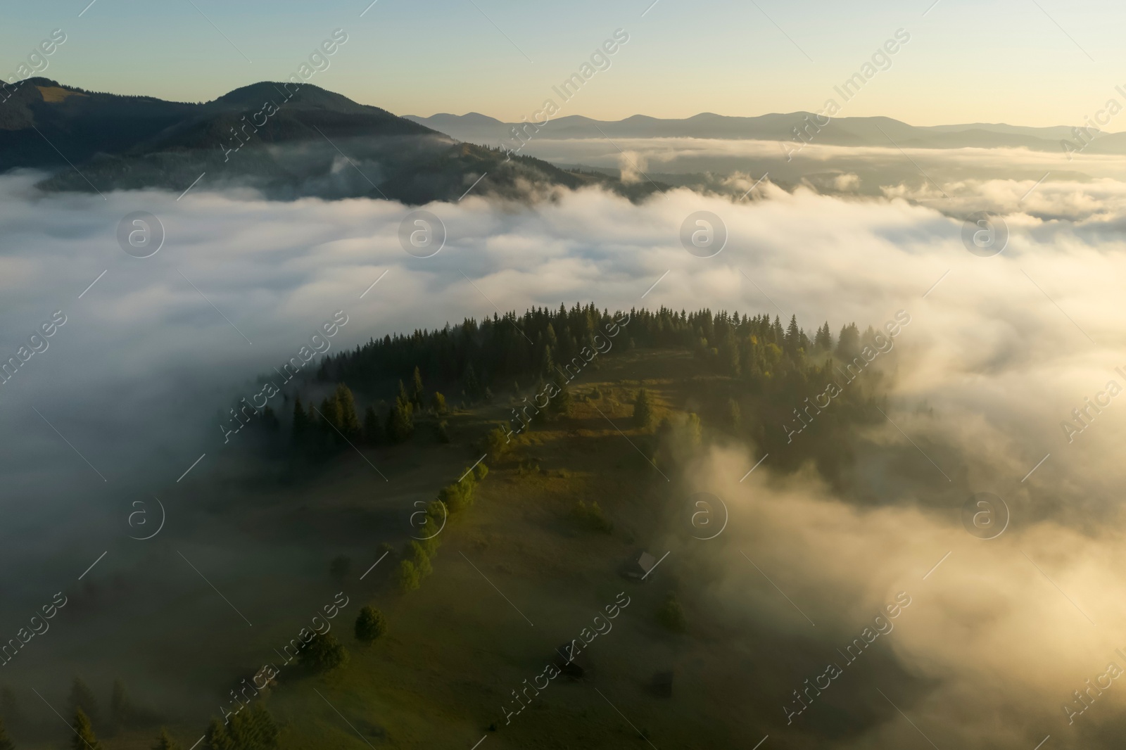 Image of Aerial view of beautiful landscape with misty forest in mountains