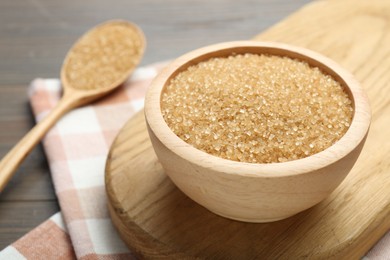 Photo of Brown sugar in bowl on table, closeup