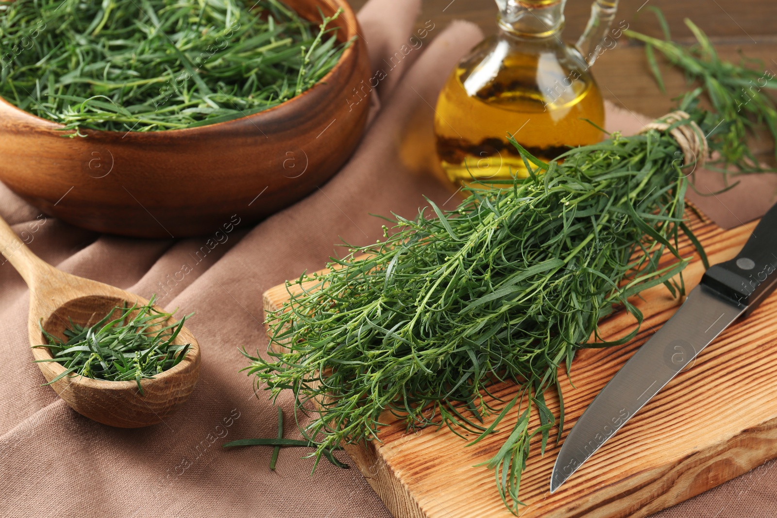 Photo of Composition with fresh tarragon sprigs on table