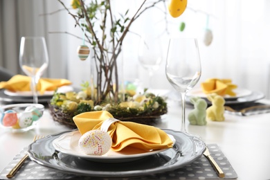 Photo of Beautiful Easter table setting with floral decor indoors