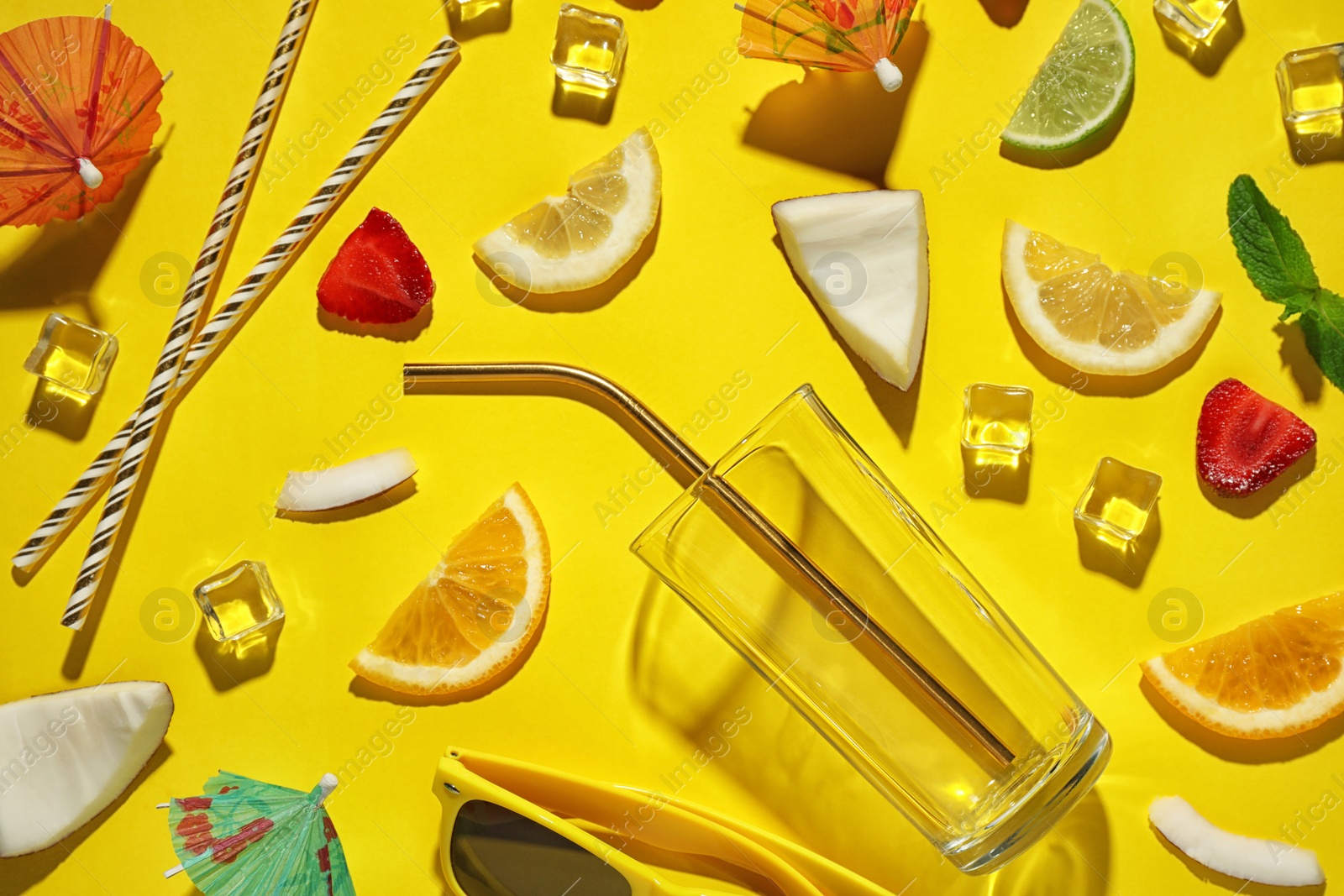 Photo of Flat lay composition with glass, sliced fruits and coconut on color background. Summer cocktail recipe