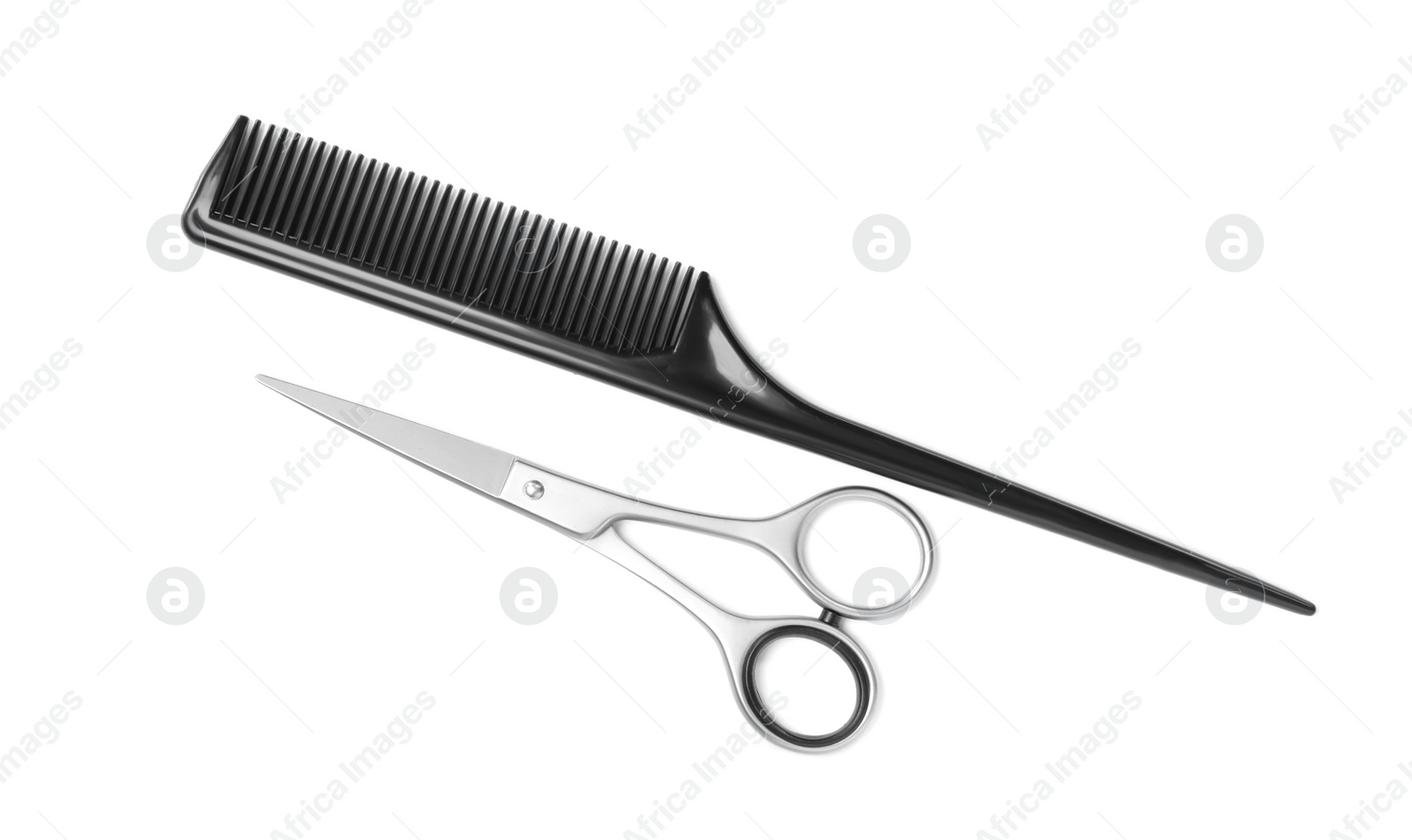 Photo of New scissors and comb on white background, top view. Professional tool for haircut