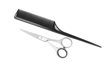 New scissors and comb on white background, top view. Professional tool for haircut