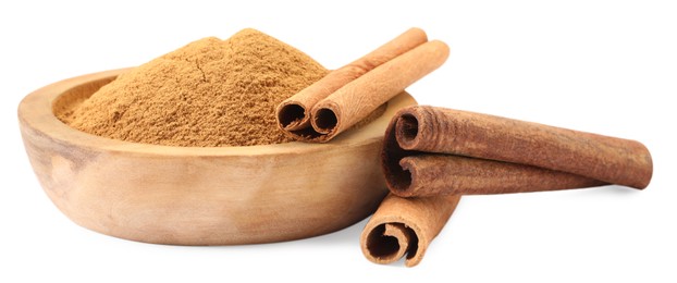 Dry aromatic cinnamon sticks and powder isolated on white