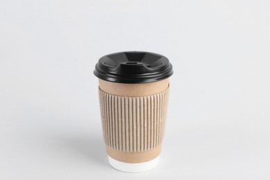 Photo of Paper cup with plastic lid on light background. Coffee to go