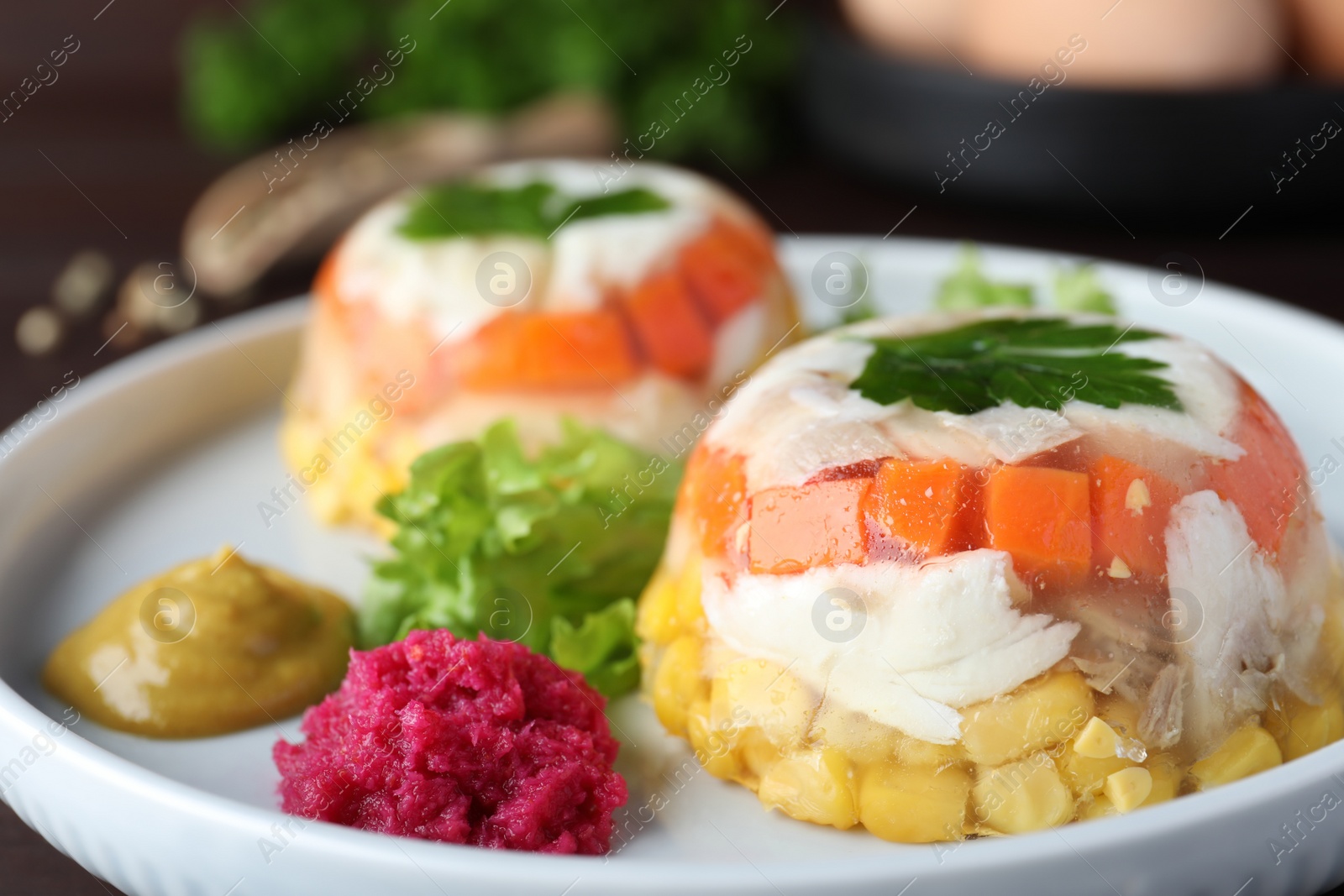 Photo of Delicious fish aspic with vegetables on plate, closeup