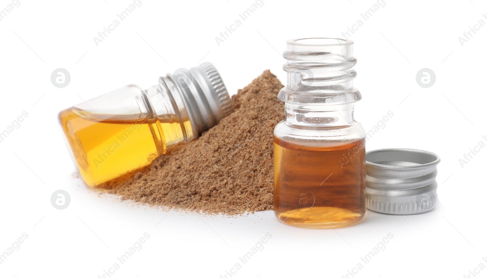 Photo of Bottles with cinnamon oil and powder on white background