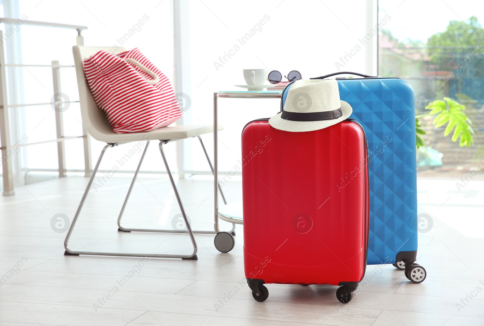 Photo of Large suitcases packed for summer journey in room