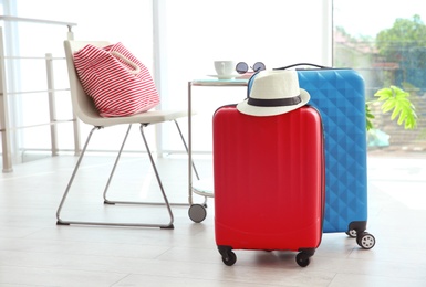 Photo of Large suitcases packed for summer journey in room