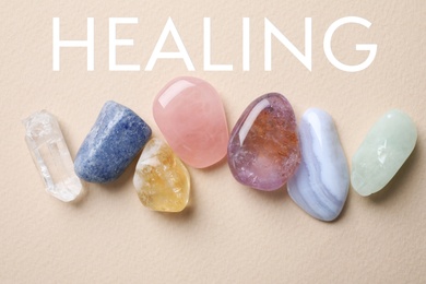 Image of Beautiful gemstones on beige background, top view. Healing crystals