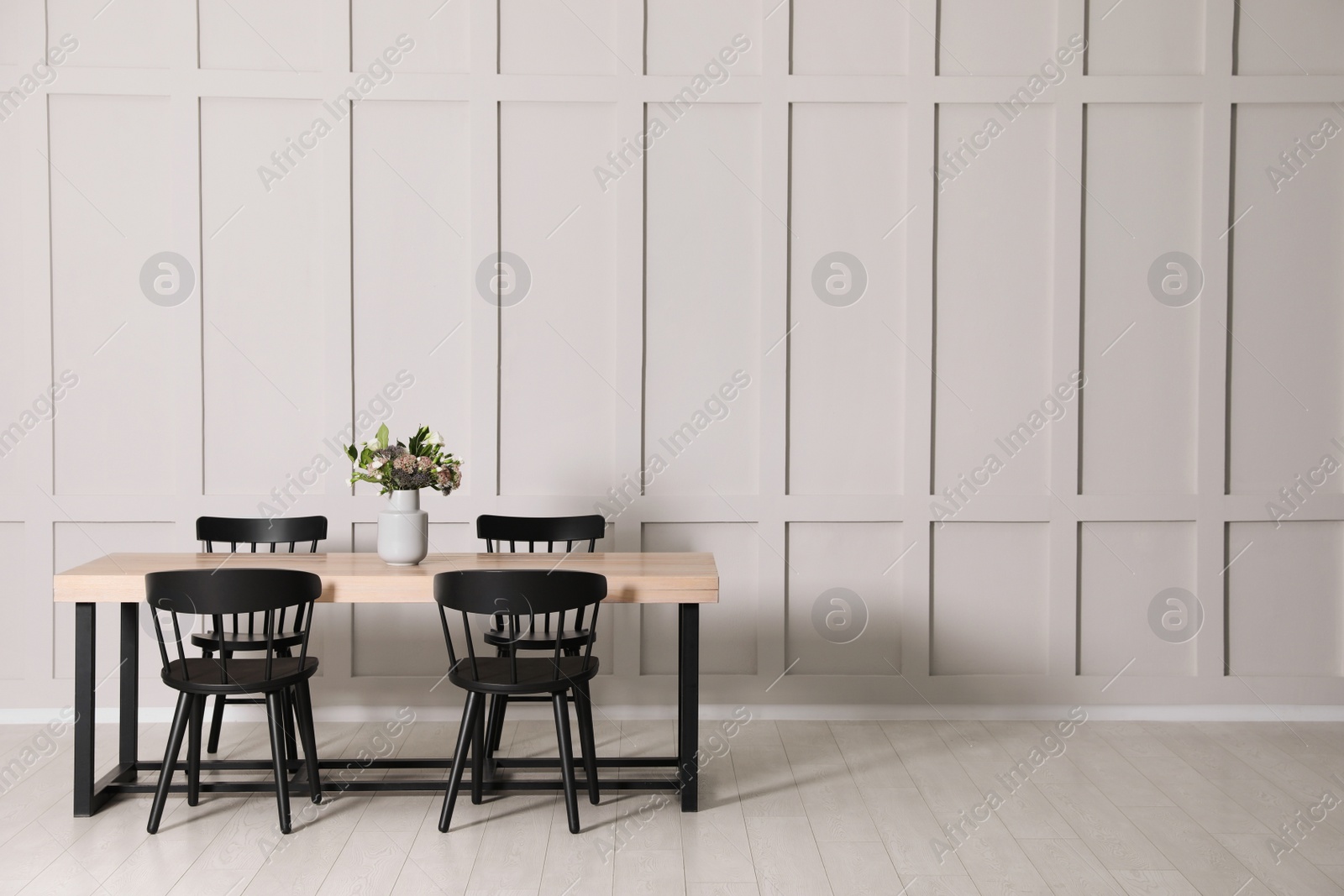 Photo of Stylish dining room interior with wooden table and chairs near molding wall, space for text