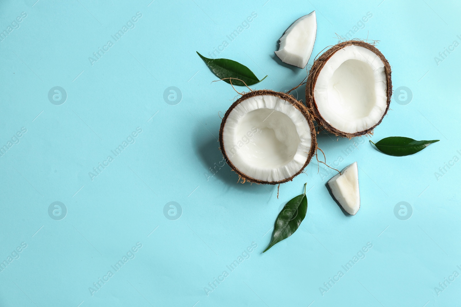 Photo of Flat lay composition with coconuts on color background. Space for text