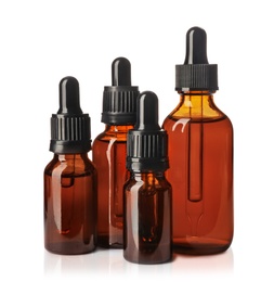 Cosmetic bottles of essential oils on white background