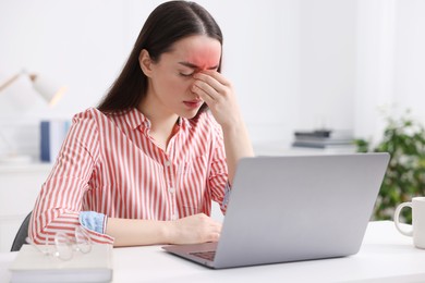 Image of Young woman suffering from headache at home