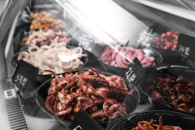 Photo of Different seafood on display, closeup. Wholesale market