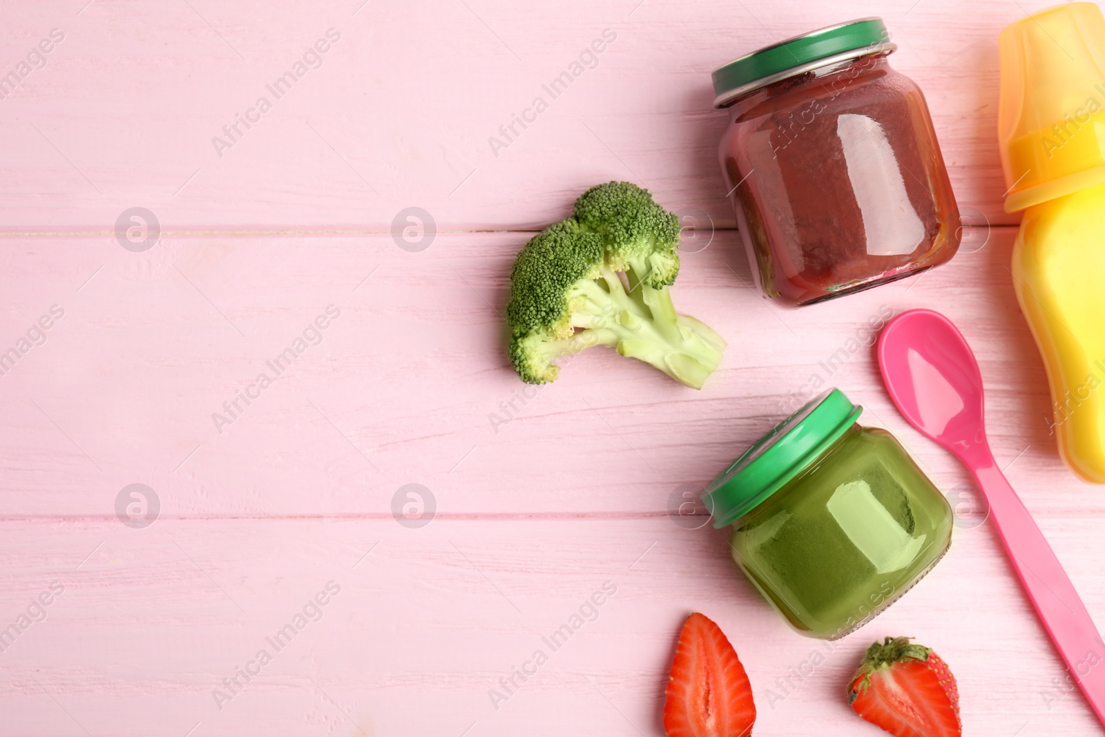 Photo of Flat lay composition with healthy baby food and ingredients on pink wooden table. Space for text