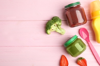 Flat lay composition with healthy baby food and ingredients on pink wooden table. Space for text